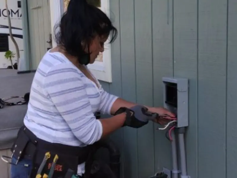 Licensed electrician wiring an exterior subpanel in Satellite Beach